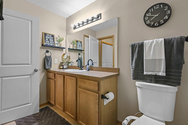 367 Ojibway Path, Lino Lakes, MN 55014 - bathroom with vanity, toilet, and a textured ceiling