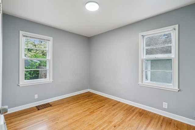 3945 15th Ave S, Minneapolis, MN 55407 - unfurnished room featuring baseboards and light wood-style floors