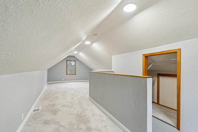 3945 15th Ave S, Minneapolis, MN 55407 - bonus room featuring carpet floors, vaulted ceiling, baseboards, and a textured ceiling