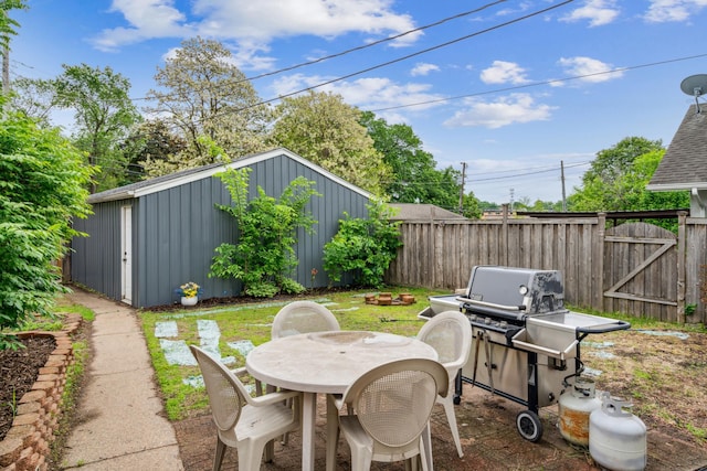3945 15th Ave S, Minneapolis, MN 55407 - view of patio / terrace with outdoor dining area, an outbuilding, and a grill