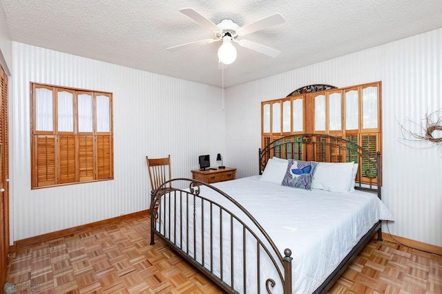 1209 5th St N, Fargo, ND 58102 - bedroom with baseboards, a textured ceiling, and ceiling fan