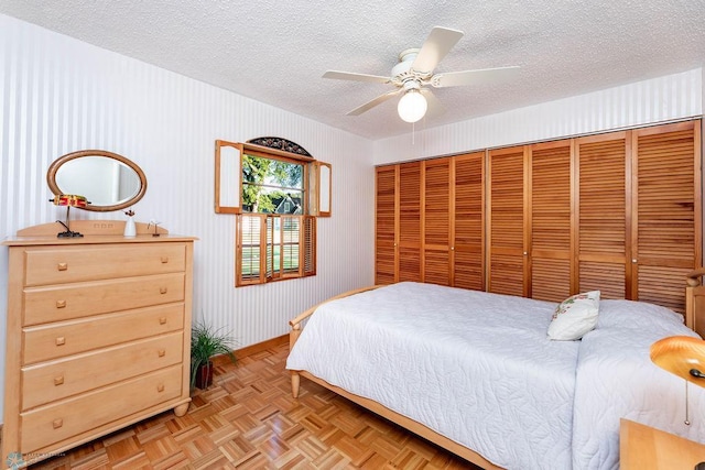 1209 5th St N, Fargo, ND 58102 - bedroom with a textured ceiling, baseboards, a closet, and ceiling fan