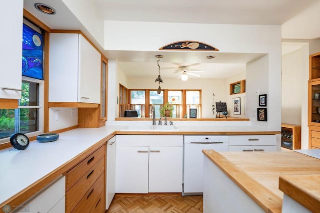 1209 5th St N, Fargo, ND 58102 - kitchen featuring dishwasher, a sink, white cabinets, and ceiling fan