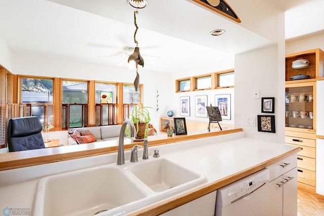 1209 5th St N, Fargo, ND 58102 - kitchen featuring dishwasher, a sink, white cabinetry, and light countertops