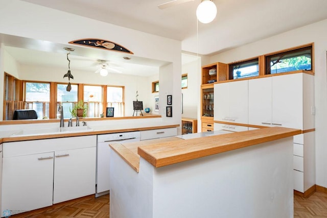 1209 5th St N, Fargo, ND 58102 - kitchen with a ceiling fan, dishwasher, a sink, and white cabinets