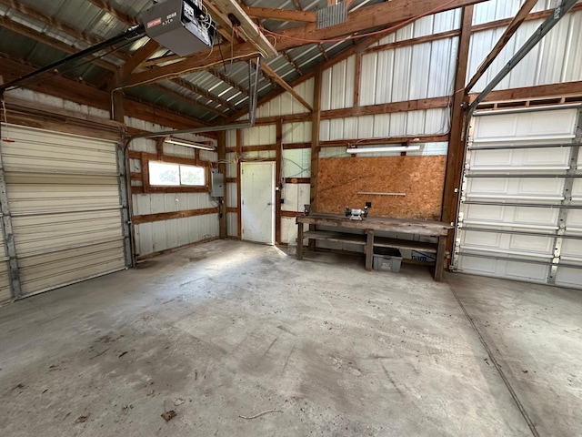 14390 Sperry Lake Rd, Harrison Twp, MN 56209 - garage featuring a garage door opener, metal wall, and electric panel
