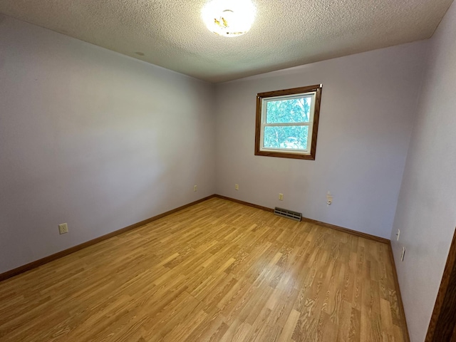 14390 Sperry Lake Rd, Harrison Twp, MN 56209 - spare room with light wood-type flooring, baseboards, and a textured ceiling