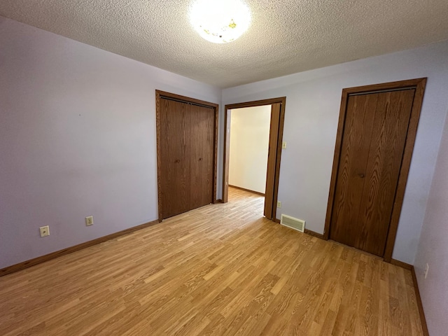 14390 Sperry Lake Rd, Harrison Twp, MN 56209 - unfurnished bedroom featuring light wood-style floors, baseboards, and a textured ceiling