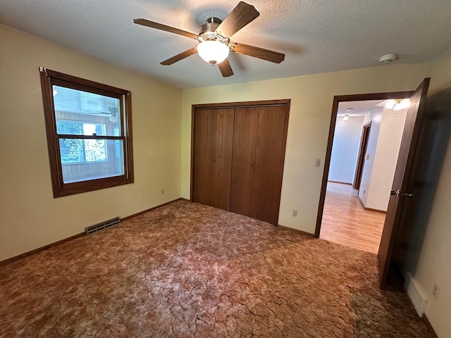 14390 Sperry Lake Rd, Harrison Twp, MN 56209 - unfurnished bedroom with carpet flooring, a closet, ceiling fan, and a textured ceiling