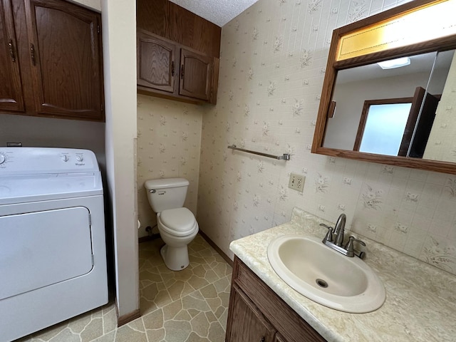 14390 Sperry Lake Rd, Harrison Twp, MN 56209 - half bath with washer / clothes dryer, vanity, toilet, and tile patterned flooring