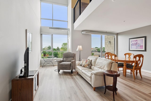 1829 3rd Ave S Unit 212, Minneapolis, MN 55404 - living room with light wood finished floors, plenty of natural light, and baseboards