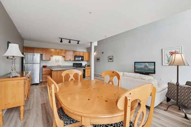 1829 3rd Ave S Unit 212, Minneapolis, MN 55404 - dining space featuring light wood-type flooring and rail lighting