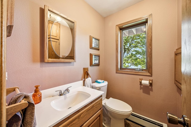 12975 185th St, Cold Spring, MN 56320 - half bathroom with baseboard heating, toilet, and vanity