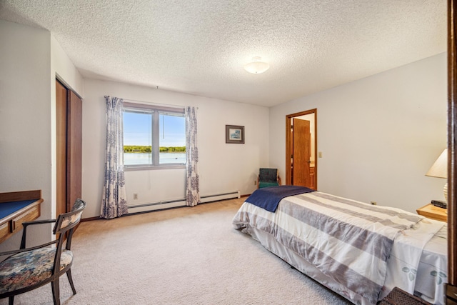 12975 185th St, Cold Spring, MN 56320 - bedroom with a baseboard radiator, light carpet, a textured ceiling, a closet, and a water view