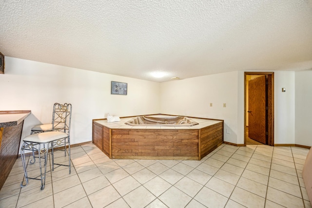 12975 185th St, Cold Spring, MN 56320 - interior space with a garden tub, a textured ceiling, tile patterned flooring, and baseboards