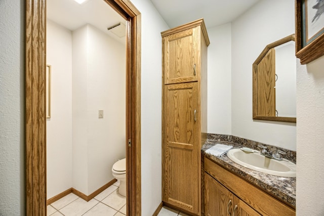 12975 185th St, Cold Spring, MN 56320 - bathroom with toilet, vanity, and tile patterned floors