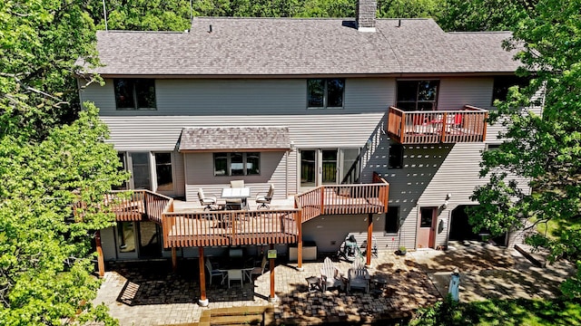 12975 185th St, Cold Spring, MN 56320 - rear view of property featuring a patio area, a chimney, roof with shingles, outdoor dining area, and a deck