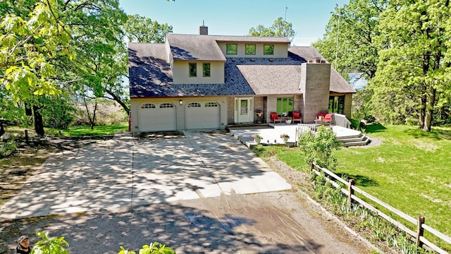 12975 185th St, Cold Spring, MN 56320 - view of front of property featuring driveway, a front lawn, a chimney, and an attached garage