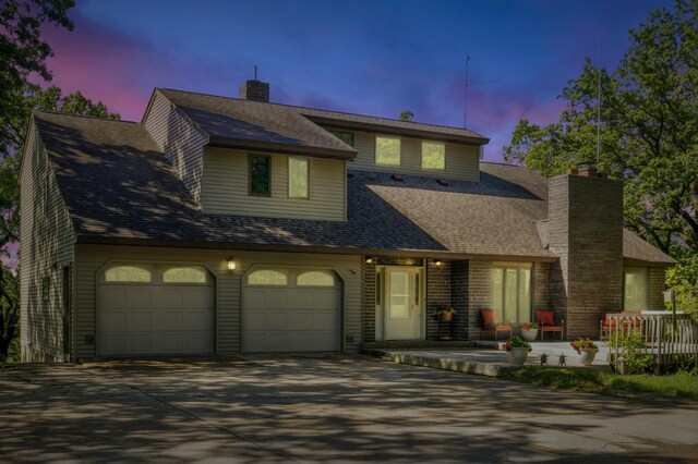 12975 185th St, Cold Spring, MN 56320 - view of front of property with concrete driveway, a chimney, an attached garage, and roof with shingles