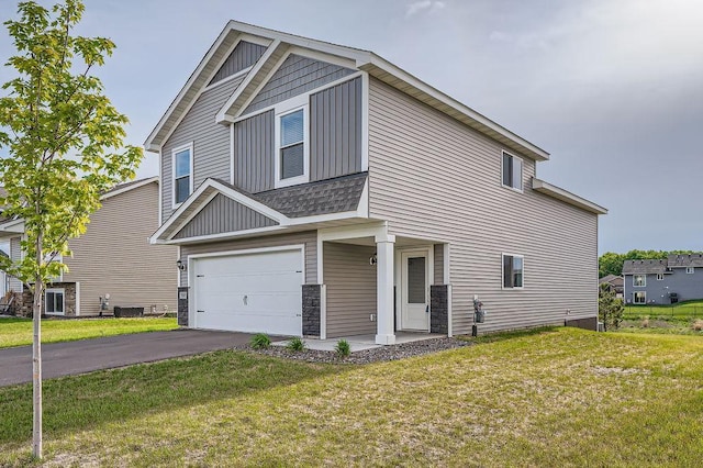 39685 Fallbrook Ave, North Branch, MN 55056 - view of front of property featuring a front yard, driveway, a garage, and stone siding
