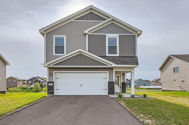 39685 Fallbrook Ave, North Branch, MN 55056 - view of front of property with stone siding, an attached garage, a front yard, and asphalt driveway