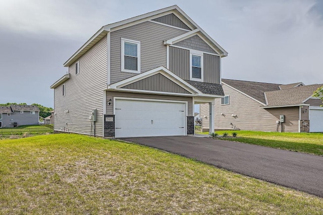 39685 Fallbrook Ave, North Branch, MN 55056 - view of front of house with driveway, a front lawn, an attached garage, board and batten siding, and stone siding