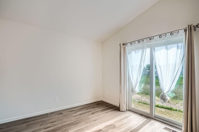 39685 Fallbrook Ave, North Branch, MN 55056 - spare room with lofted ceiling, healthy amount of natural light, wood finished floors, and baseboards