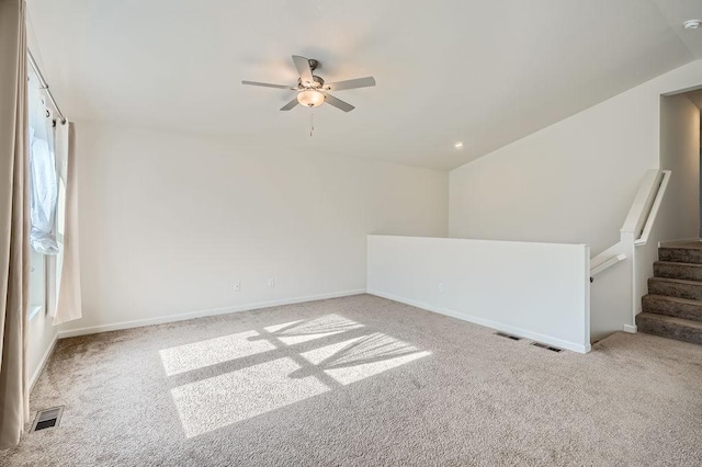 39685 Fallbrook Ave, North Branch, MN 55056 - spare room with carpet flooring, a ceiling fan, baseboards, vaulted ceiling, and stairway