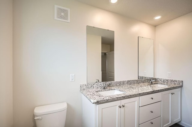 39685 Fallbrook Ave, North Branch, MN 55056 - bathroom with double vanity, toilet, and recessed lighting