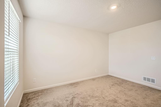39685 Fallbrook Ave, North Branch, MN 55056 - empty room with carpet floors, a textured ceiling, baseboards, and recessed lighting