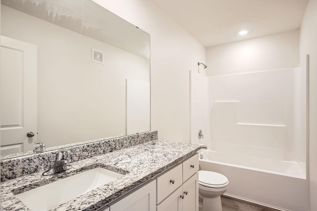 39685 Fallbrook Ave, North Branch, MN 55056 - bathroom featuring toilet, vanity, bathtub / shower combination, and wood finished floors