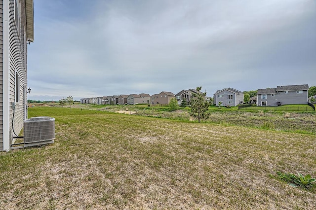 39685 Fallbrook Ave, North Branch, MN 55056 - view of grassy yard with central AC and a residential view
