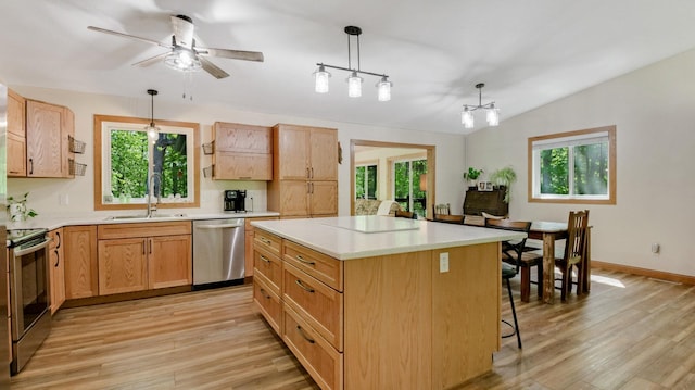 3015 Aspen Ter, Scott Twp, WI 54830 - kitchen with stainless steel appliances, a sink, light wood-type flooring, plenty of natural light, and lofted ceiling