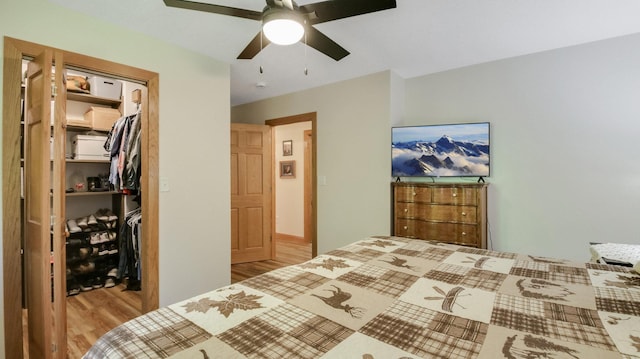 3015 Aspen Ter, Scott Twp, WI 54830 - bedroom featuring wood finished floors, a closet, a spacious closet, and ceiling fan