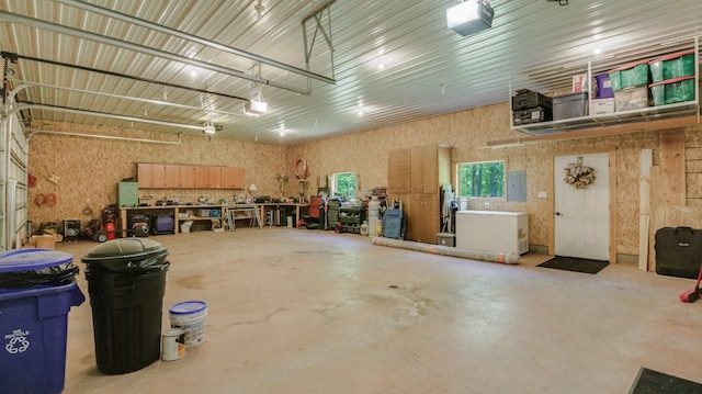 3015 Aspen Ter, Scott Twp, WI 54830 - garage with a garage door opener, a workshop area, and electric panel