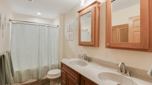 3015 Aspen Ter, Scott Twp, WI 54830 - full bath featuring double vanity, toilet, and wood finished floors