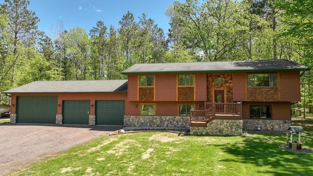 3015 Aspen Ter, Scott Twp, WI 54830 - view of front of property featuring stone siding, driveway, a front lawn, and a garage