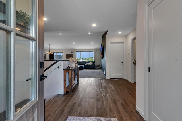 419 Bluebird Dr NW, Isanti, MN 55040 - kitchen featuring dark wood-type flooring, dark countertops, open floor plan, white cabinetry, and recessed lighting