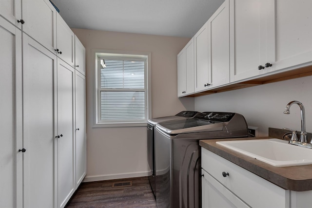 419 Bluebird Dr NW, Isanti, MN 55040 - laundry room with separate washer and dryer, cabinet space, dark wood-style floors, and baseboards