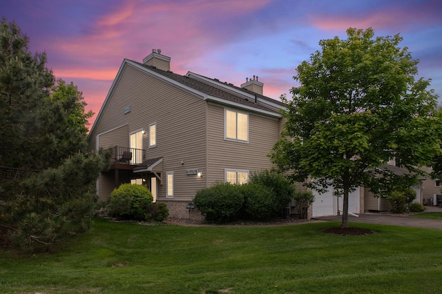 2225 Ranchview Ln N Unit 1, Plymouth, MN 55447 - property exterior at dusk featuring a chimney, a lawn, driveway, and a garage