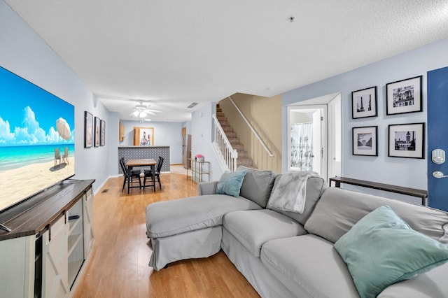 2225 Ranchview Ln N Unit 1, Plymouth, MN 55447 - living area with stairway, a ceiling fan, and light wood-type flooring