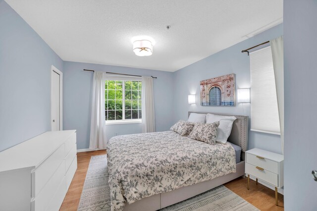 2225 Ranchview Ln N Unit 1, Plymouth, MN 55447 - bedroom with light wood-style floors and baseboards