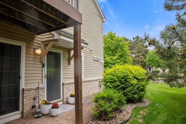 2225 Ranchview Ln N Unit 1, Plymouth, MN 55447 - view of exterior entry featuring a lawn and brick siding
