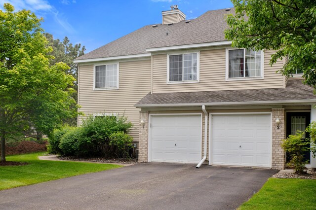 2225 Ranchview Ln N Unit 1, Plymouth, MN 55447 - view of front facade with roof with shingles, asphalt driveway, and an attached garage