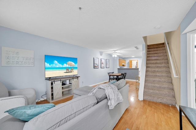 2225 Ranchview Ln N Unit 1, Plymouth, MN 55447 - living room with stairway, light wood-style floors, and a ceiling fan