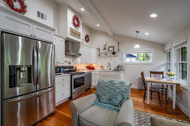 30124 Circle Dr, Breezy Point, MN 56472 - kitchen with stainless steel appliances, wall chimney range hood, lofted ceiling, white cabinetry, and decorative backsplash