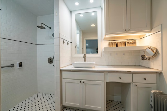30124 Circle Dr, Breezy Point, MN 56472 - full bathroom featuring tiled shower, radiator heating unit, vanity, tasteful backsplash, and recessed lighting