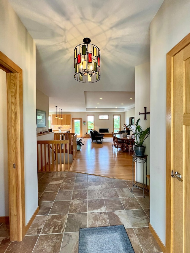 2774 Pine Ridge Blvd, Red Wing, MN 55066 - corridor featuring stone finish floors, baseboards, recessed lighting, and a chandelier