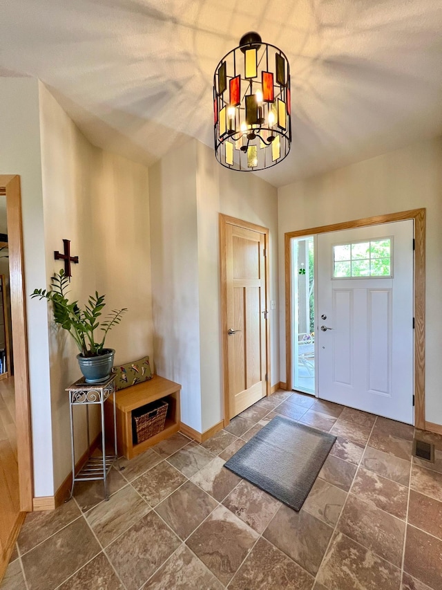 2774 Pine Ridge Blvd, Red Wing, MN 55066 - entrance foyer with baseboards, stone tile flooring, and a chandelier
