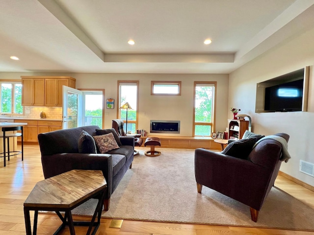 2774 Pine Ridge Blvd, Red Wing, MN 55066 - living room with plenty of natural light, recessed lighting, a raised ceiling, and light wood-type flooring